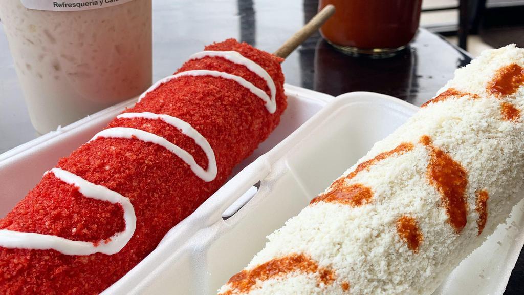 Elote Entero Hot Cheetos! · Whole Seasoned Mexican White Corn with Mayo, Salt, Lime, Fresh Cotija Cheese and then covered with crushed Hot Cheetos.