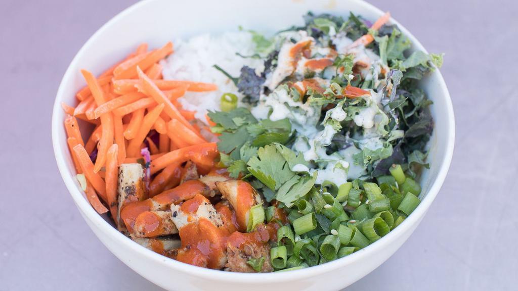 Buffalo · Spicy. Sriracha lime buffalo chik'n, dill peppercorn ranch, cilantro, kale super food salad, sriracha lime buffalo sauce, carrots, and scallions on a bed of jasmine rice.