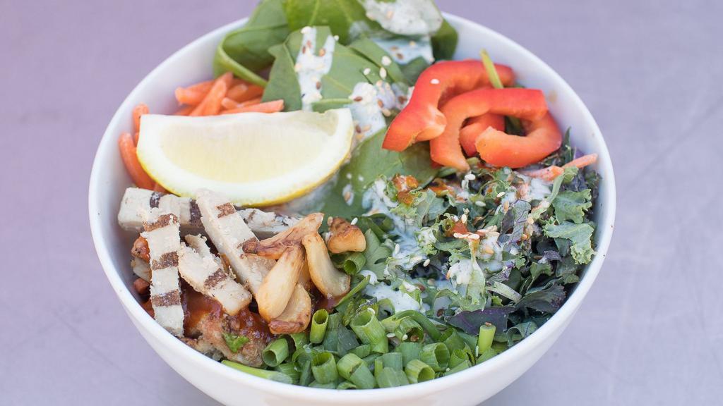 Big Chik'N Salad · On a bed of spinach, green cabbage, red cabbage, red peppers, scallions, pepperoncinis, carrots, kale super food greens, tamari, dill peppercorn ranch, toasted sesame seeds and roasted garlic cloves.
