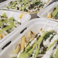 Carne Asada Fries · French fries, topped with shredded cheese, nacho cheese, choice of meat, cilantro, onions, s...