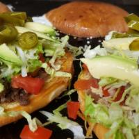 Tortas · Beans, lettuce, choice of meat, tomatoes, onions, jalapeños, avocado, cheese.