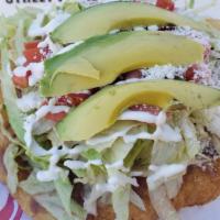 Tostadas · Beans, cotija cheese, lettuce, tomatoes, sour cream and avocado sauce and sliced avocado