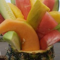 Piñas Locas · Whole pineapple filled with mixed fruits sprinkled with chamoy tajin and lime, salsaghetti c...