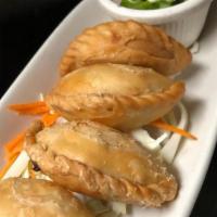 Karee Puff: · Red potato, caramelized onion, carrot wrapped in pastry skin. 
Served with cucumber salad.