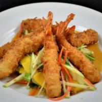 Coconut Shrimp: · Golden-fried coconut shrimp on a bed of fruit salad 
tossed with lime sauce.