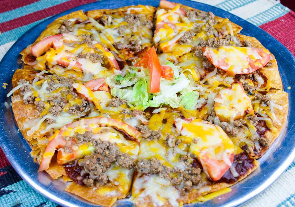 Deluxe With Ground Beef · Crispy tortilla with melted cheese, New Mexican red chile, tomatoes and ground beef. Spicy.