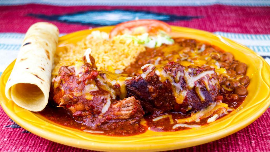 Adovada Ribs · Boneless country style pork ribs marinated and served with New Mexican red chile, cheese, chile beans, rice and a homemade flour tortilla. Spicy.