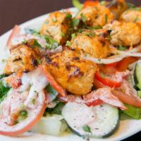 Chicken Kebab Salad* · Grilled chicken breast, romaine, red peppers, tomatoes, cucumbers, onions, and house garlic ...