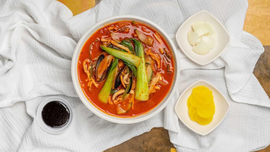 Jjam Ppong · Spicy seafood noodle soup with pork, veggies, mussel, and squid.