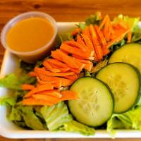 House Salad · Green leaf with cucumbers and carrots.  Served with a side of our house ginger dressing.