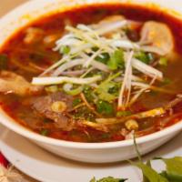 Bún Bò Huế / Spicy Beef Noodle Soup · Spicy beef soup with beef shank, Vietnamese ham, pork blood and steamed pork leg.