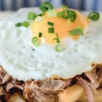 Loco Fries · Golden brown fries, kalua pork, grilled onions, gravy, and sunny-side up egg.
