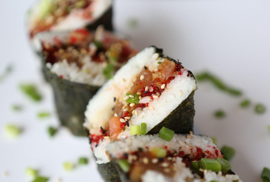 Da Poke Musubi · Shoyu ahi tuna or salmon, tobiko, furikake with rice, wrapped in nori. Topped with green onions.