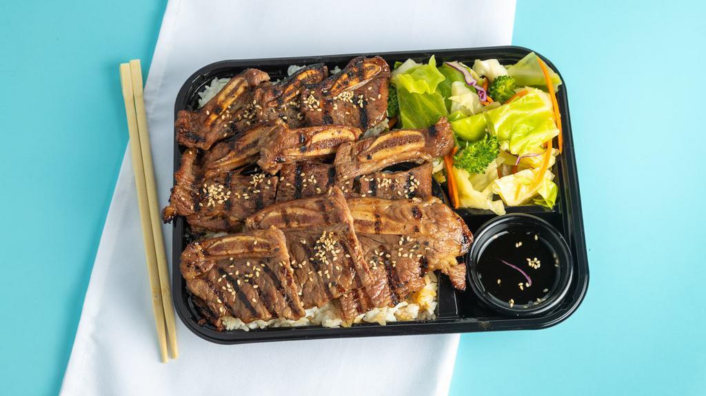 Beef Short Ribs · Strips of marinated beef short ribs (bone-in). Includes white rice, drizzle of Joybox's teriyaki sauce + fresh salad.