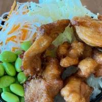 Chicken Karaage Bowl · Japanese style fried chicken over rice with cabbage, edamame, and carrots. Served with Chili...