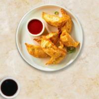 Red Chili Dumplings · Six deep-fried dumplings topped with sweet chili sauce, and cilantro.