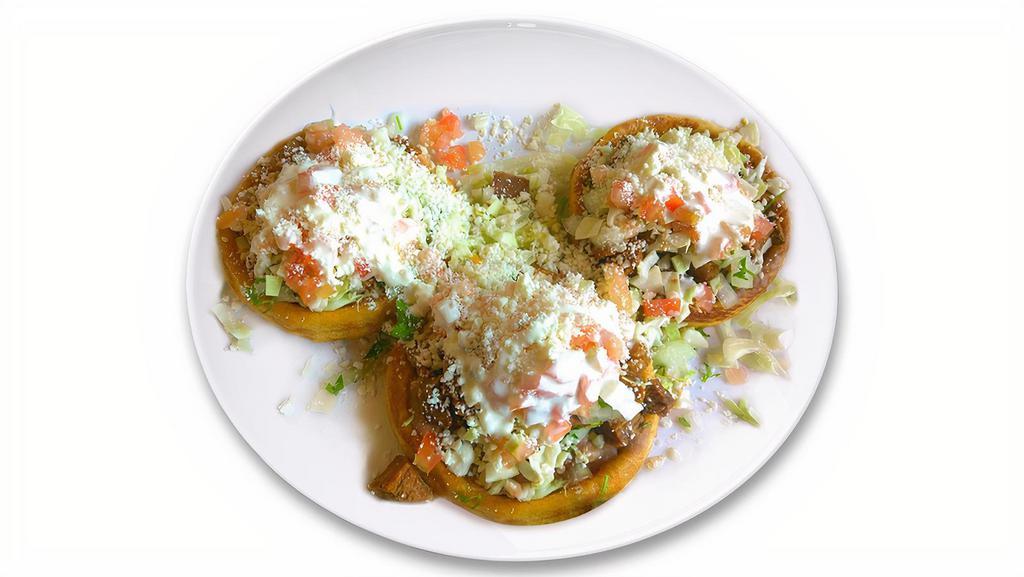Sopitos (3) · Your choice of meat, beans, onions, cilantro, cabbage, tomato, cheese, Mexican cream, salsa.
