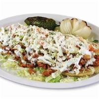 Huarachi · Corn tortilla shell topped with your choice of meat, beans, onions, salsa, cilantro, lettuce...