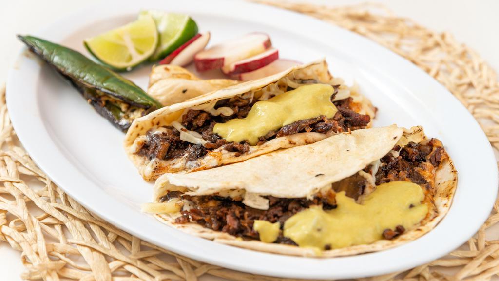 Tacos Suizo  · Corn tortilla with asada meat cut from el trompo, with cheese and salsa. Each