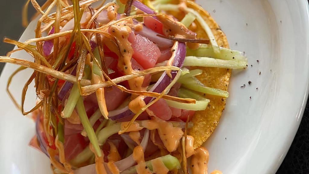 Tostada De Atun Fresco · Fresh tuna cubes mixed with cucumber, onion and
salsa negra, finished with chipotle dressing and
fried leek.