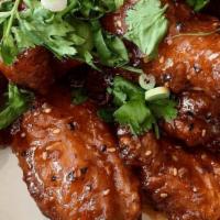 Yum Yum Crispy Wings · Deep fried chicken wings topped with chili lime dressing. Choose your spice level: mild, med...