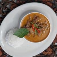 Panang Curry · Panang curry in coconut milk topped with kaffir lime leaves.