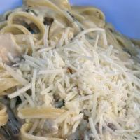 Fettuccine Alfredo · Our delicious cream sauce with spinach and mushrooms topped with parmesan cheese.
