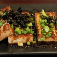 Grilled Tofu · Tofu grilled and topped with scallions, seasoned seaweed, and sweet soy glaze. Served with s...
