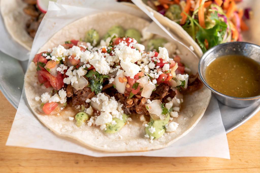 Beef Taco · Made without gluten. Braised 100% pasture raised beef, avocado crema, pico de gallo, and queso fresco.
