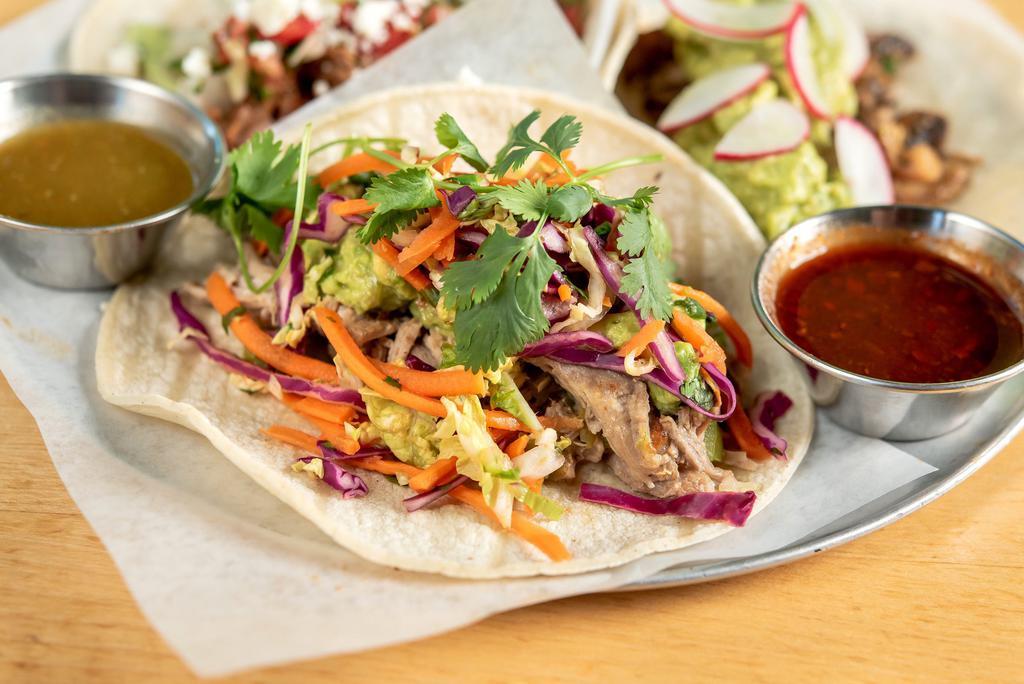 Pork Taco · Made without gluten. Pulled pork, green chiles, verde sauce, guacamole, and cilantro-lime slaw.