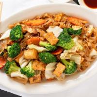 Pad Seiw · Thick rice noodles stir fried with broccoli, carrots, cabbage, and eggs in our black sweet b...
