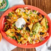 The Works Nachos · Chips topped with beans, melted cheese, sour cream, guacamole, olives, onions, and tomatoes....