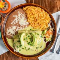 Spinach & Mushroom Enchiladas · Two enchiladas topped with a homemade poblano cream sauce. Served with rice, beans, and avoc...
