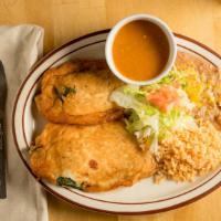 Mexican Chile Rellenos · Chiles stuffed with cheese, fried, and smothered in green chile. Served with beans, rice, an...