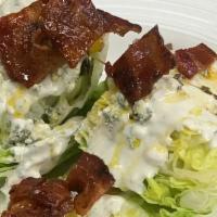 Chopped Wedge Salad · Gluten Friendly. Candied bacon, chive oil, confit tomatoes, crumbled bleu cheese, bleu chees...