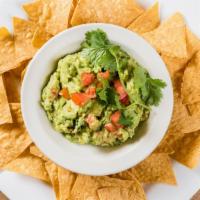 Holy Guacamole · A heaping scoop of fresh guacamole and warm tortilla chips
