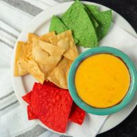 Chile Con Queso Dip · Delicious combination of two types of cheese, blended with anaheim and jalapeño peppers, tom...