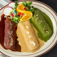 Holy Mole · Three chicken enchiladas each smothered with a different homemade mole (green, white and red).