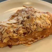 Almond Croissant · Twice-baked croissant with almond cream, topped with sliced almonds and powdered sugar