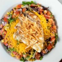 South Of The Border · Grilled chicken on a bed of mixed greens, black beans, roasted corn, cheddar cheese, pico de...