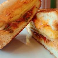 The Jam Sandwich · challah bread, tomato jam, white cheddar, Calabrian chili mayo and scrambled eggs