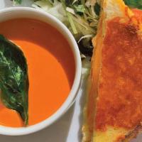 Grilled Cheese And Tomato Soup · half inside out grilled cheese sandwich served with tomato soup and kale and cabbage side sa...