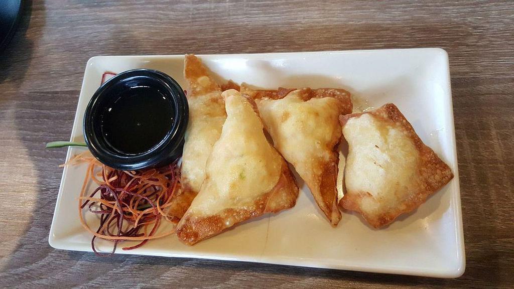 Crab Puff · cream cheese, snow crab, deep fried in wonton skin. Served with plum sauce.