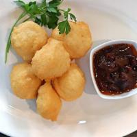 Akara “Black Eyed Pea Fritters” · Blacked-Eyed pea fritters served with a savory onion sauce. A vegetarian delight!