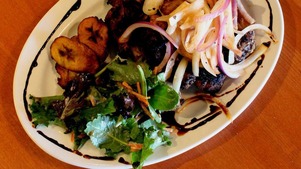 Debi Afra / Suya “Grilled Meat” · Popular Senegambian street food. Meat marinated in authentic Calabash seasonings and char-grilled. Served with pickled onions, spicy mustard and small salad.