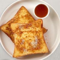 Classic French Toast · Fresh bread battered in egg, milk, and cinnamon cooked until spongy and golden brown. Topped...