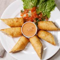 Mini Chimis · Six slices of chimichanga deep fried to golden brown, choice your meat ( shredded beef or ch...