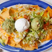 Nachos · Homemade tortilla chips topped with your choice of meat ( ground beef or chicken) beans, mel...