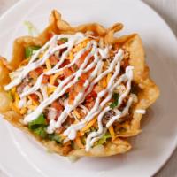 Taco Salad · Flour tortilla shell filled with your choice of meat, shredded Chicken or shredded beef, bea...
