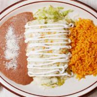 Enchiladas Verdes · Two chicken enchiladas topped with verde sauce, melted jack cheese, and sour cream, served w...